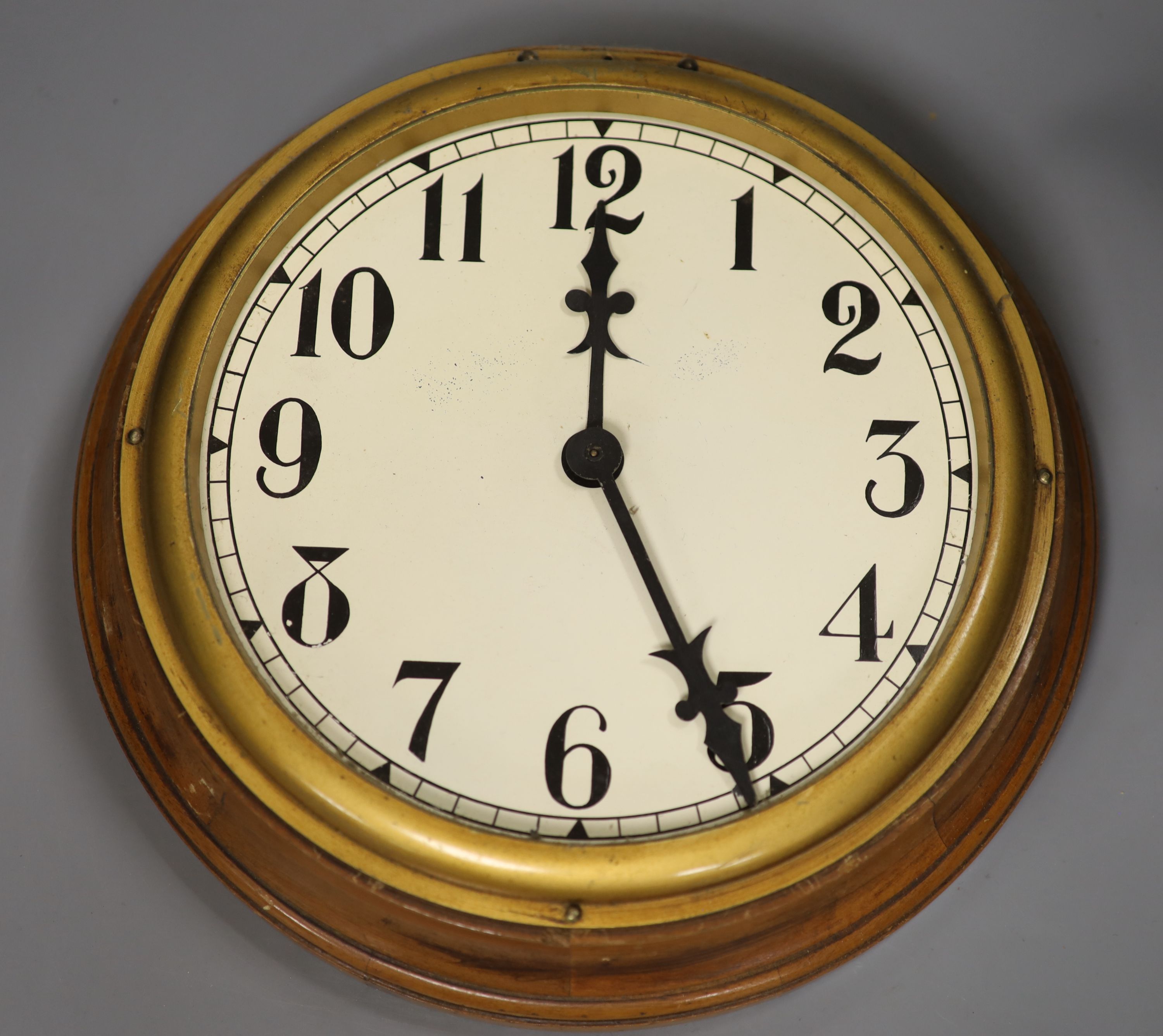 An oak cased electric slave dial, diameter 31cm